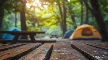 wood table and blurred camping and tents in forest. good morning and fresh start of the day.