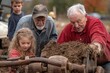 © Milos - An elderly man, another older man, and a young girl work together on a dirt-covered machine, symbolizing family cooperation and multi-generational collaboration in an outdoor setting.