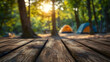 © john - Wood table and Blurred camping and tents in forest. Good morning and fresh start of the day.