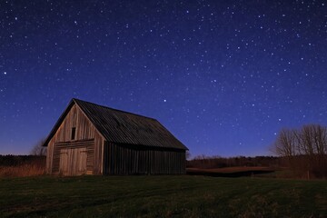 a starry night over a rustic barn in the countryside, celestial wonder, rural serenity