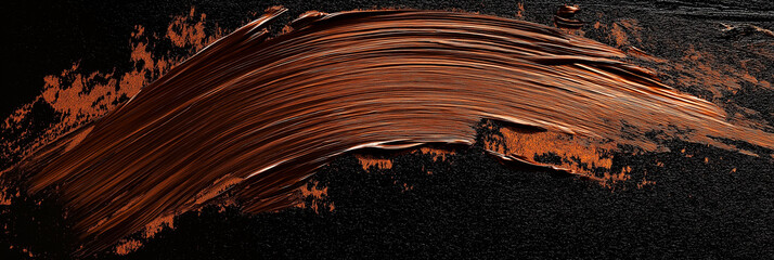 bright brown brush stroke of paint on black background