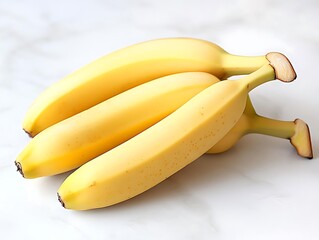 Wall Mural - Photo of Ripe Yellow Bananas on a White Marble Background