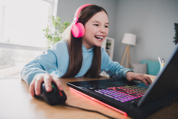 Poster - Photo of cheerful cute lovely girl little gamer playing online video computer game room indoors