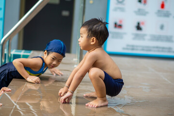 Sister and brother kids enjoying swim in condominium pool outdoor exercise