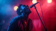 © Raitalinn - A male singer captivates the audience under red and blue lights, his voice resonating with passion.