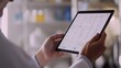 © Nathaphat - Efficient Healthcare Management: Professional Reviewing Patient's Treatment Plan on Tablet