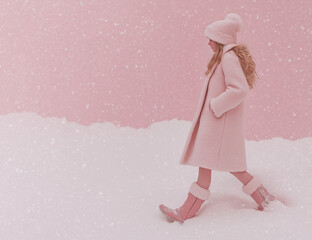 Wall Mural - A pastel pink winter scene of a pretty girl walking through falling snow, wearing a cozy hood pulled over her head, embracing the season's fashion.







