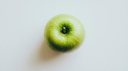 Wall Mural - Green apple on a white background, highlighting health and nutrition