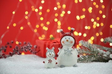 Wall Mural - Cute decorative snowmen and other Christmas decor on artificial snow