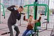 © Studio Peace - Father and son in the street gym in the park.