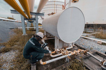 Wall Mural - Male worker inspection and measurement thickness pipeline oil and gas at check record