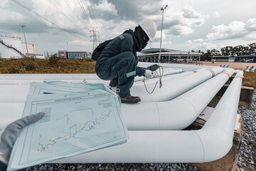 Wall Mural - Male worker inspection and measurement thickness pipeline oil and gas at check record pipeline