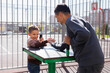 © Studio Peace - Father and son in the street gym in the park.