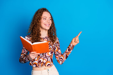 Poster - Photo portrait of lovely young lady read book point look empty space dressed stylish colorful garment isolated on blue color background