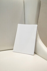 Wall Mural - magazine with blank cover on white leather sofa