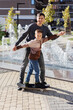 © Studio Peace - Father teaches her son to skateboard. Fatherhood, sports and leisure together with the family.