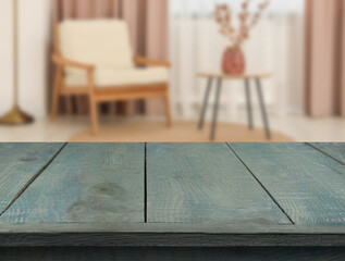 Poster - Empty turquoise wooden table near armchair, side table and window with curtains. Space for design