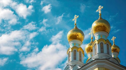 Golden domes of an Orthodox church glistening under the Russian sun with blue sky backdrop.