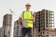 © Studio Peace - Architect is talking on the phone at a construction site in a protective helmet and vest.