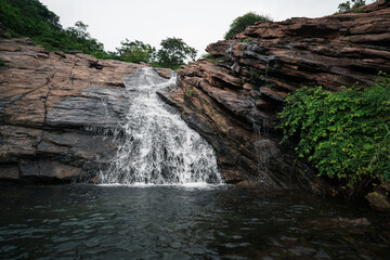 Rock Formation and Waterfall Photo, Stunning Natural Landscape, Peaceful Waterfall Oasis, Cascading Beauty Hidden Waterfall, Nature's Symphony Adobe Stock Photo. 