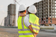 © Studio Peace - Portrait of a father and daughter in protective helmets on the background of a construction site.