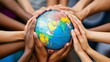 © Matthew - A diverse group of hands holding a globe, symbolizing unity and global cooperation.
