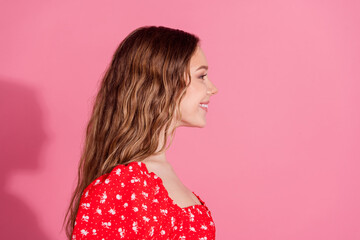 Poster - Photo portrait of attractive teen woman look empty space profile dressed stylish red clothes isolated on pink color background