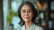 © Руслан Галиуллин - portrait of 60 year old happy well-groomed Asian woman at home