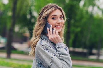 Sticker - Profile photo of pretty young woman toothy smile speak phone wear denim jacket free time walk fresh air park outdoors