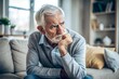 © Introvertia - Thoughtful elderly man contemplative on couch