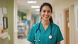 © ibooM - A woman in a green scrubs is smiling and wearing a stethoscope at hospital