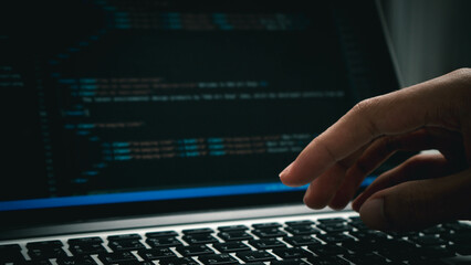 Developing programmer, software developer coding computer code on laptop computer. Digital software development. Website and mobile app design and coding technologies.