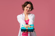 © kohanova1991 - Happy charming woman gift box on pink background. Young girl smiling, gives you