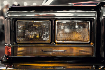 Wall Mural - Close-up photo of headlights of an old classic car
