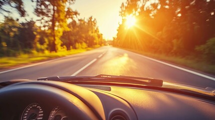 driving on a country road at sunset with sun glare