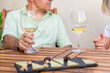 © ADDICTIVE STOCK - Mature Couple Enjoying Wine and Cheese on Outdoor Patio