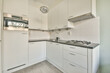© ADDICTIVE STOCK - Modern kitchen interior with sleek white cabinets