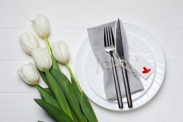 Canvas Print - Table setting for romantic Valentine's day celebration, top view. Plates, cutlery and flowers on white wooden table