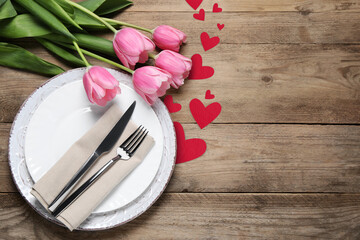 Canvas Print - Table setting for romantic Valentine's day celebration, top view. Plates, cutlery, flowers and hearts on wooden table, space for text