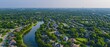 © Starkreal - Tranquil Suburban Bliss: Aerial View of Tree-Lined Streets and Residential Houses in Quality