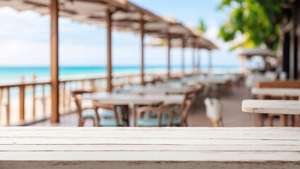 Wall Mural - The empty white wooden table top with blur background of restaurant on the beach. For product display