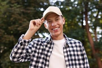 Wall Mural - Portrait of smiling man in baseball cap outdoors