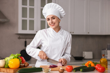 Wall Mural - Professional chef cutting onion at table in kitchen