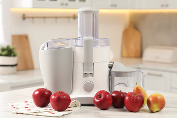 Modern juicer, pears and apples on white marble table in kitchen