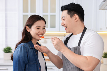 Wall Mural - Happy lovely couple cooking together in kitchen