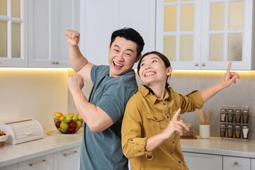 Canvas Print - Happy lovely couple dancing together in kitchen