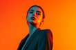 © Blockbits - Chic Womans Dark Gray Suit with Solid Neon Orange Fashionable Lifestyle Portrait Background