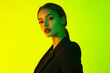 © Blockbits - Stylish Womans Black Suit with Solid Neon Yellow Modern Lifestyle Portrait Background