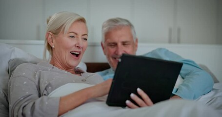 Canvas Print - Mature couple, bed and tablet with laughing, digital scroll and tech learning with help and support. Talking, social media and online in home with discussion together in bedroom with people and love