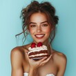 © Vivid_Vision - A 30-year-old woman presenting a piece of cake, with a joyful expression, on a light blue background
